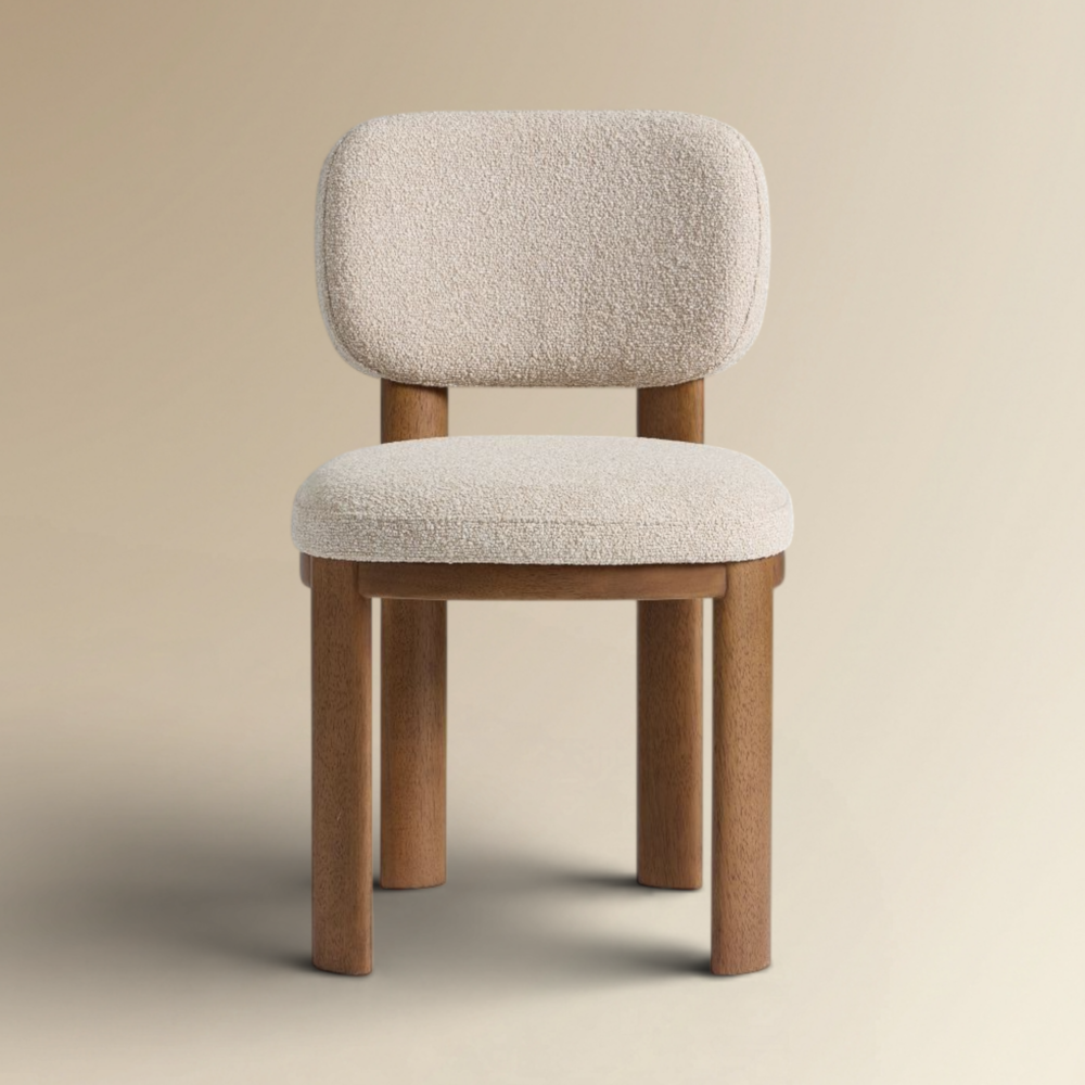 Aaron modern dining chair with a chunky wood frame and white textured bouclé upholstery.